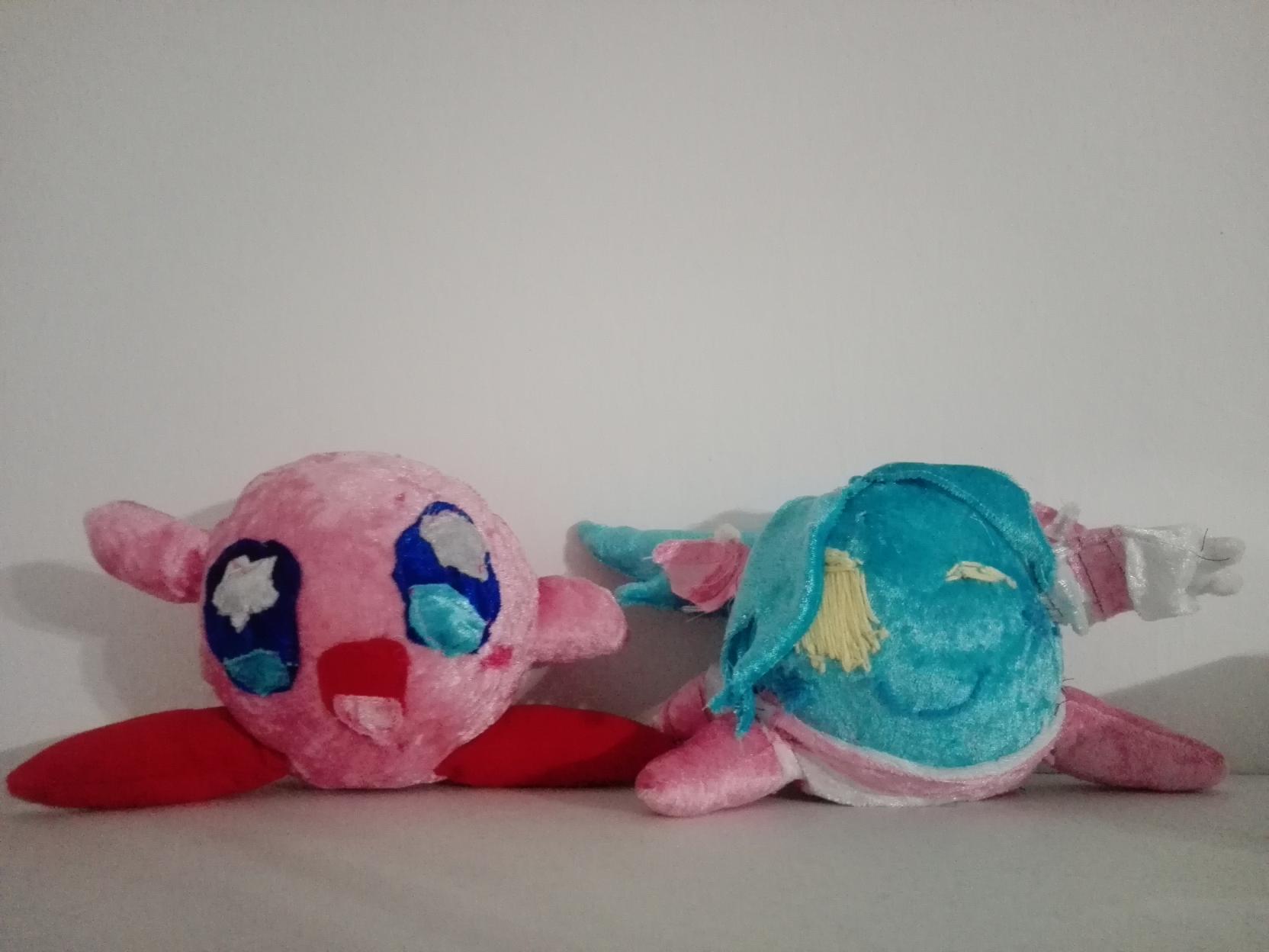Plushies of Kirby and an outdated design of Rainberry, my Kirbysona and the site's mascot